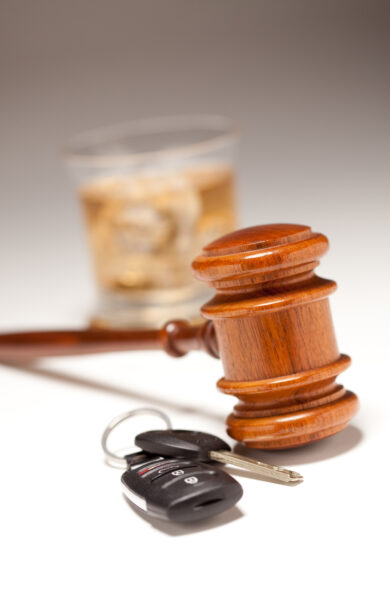 Gavel, car keys, and a glass of whiskey symbolizing DWI/DUI legal issues in New Jersey.